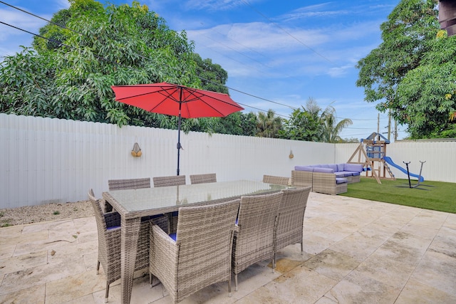 view of patio featuring a playground and an outdoor living space