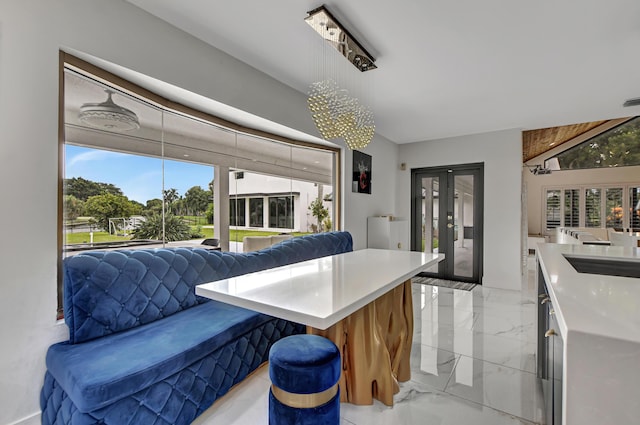 kitchen featuring a breakfast bar and a notable chandelier