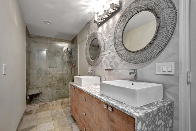 bathroom featuring tile walls, a shower with shower door, and vanity