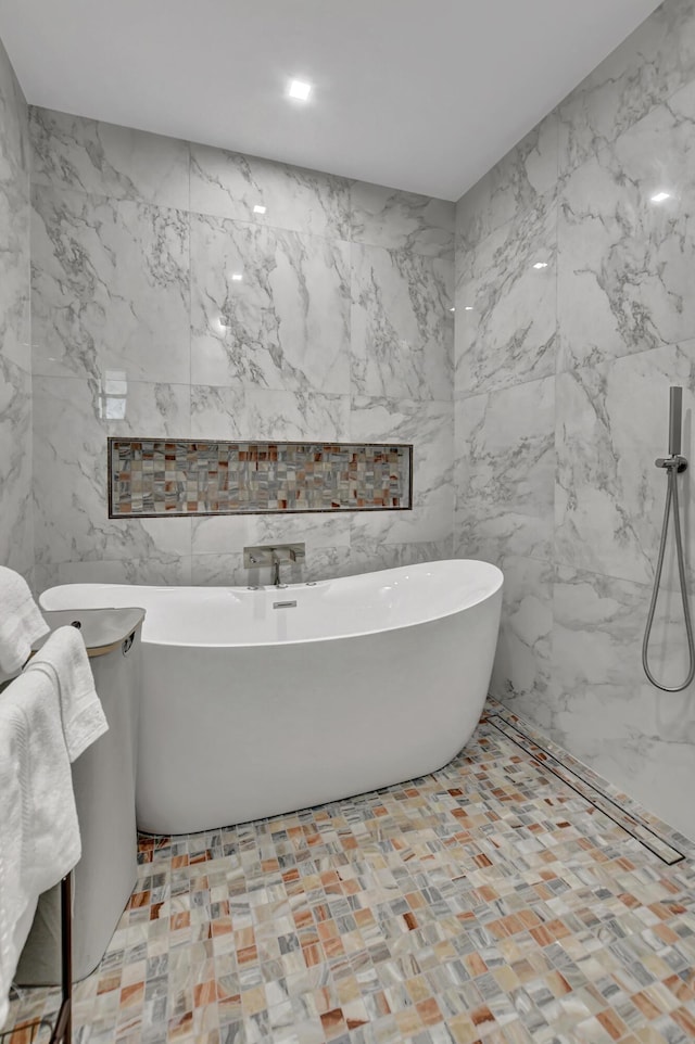 bathroom featuring tile walls and a bathtub