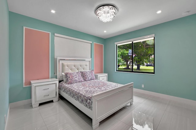 tiled bedroom featuring an inviting chandelier