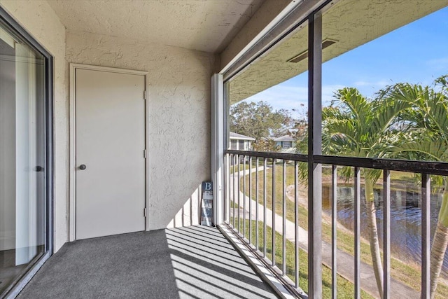 balcony featuring a water view