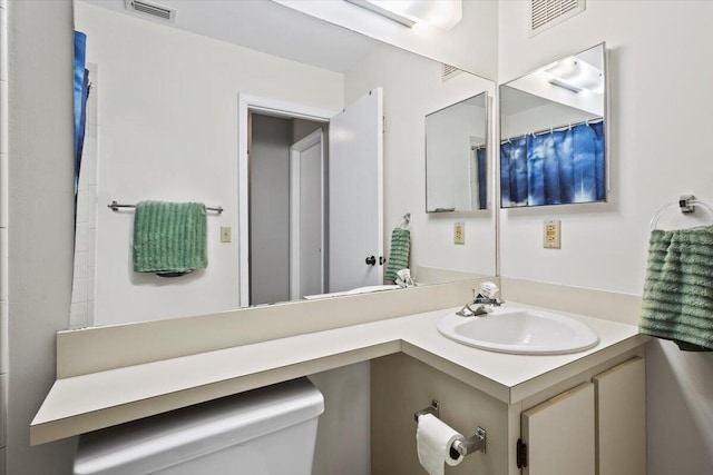 bathroom with vanity and toilet