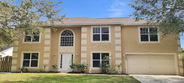 view of front of house with a front yard and a garage