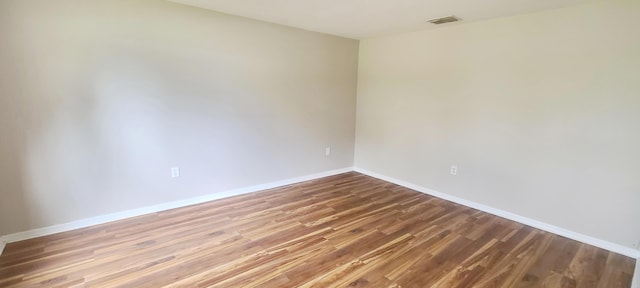 unfurnished room with wood-type flooring