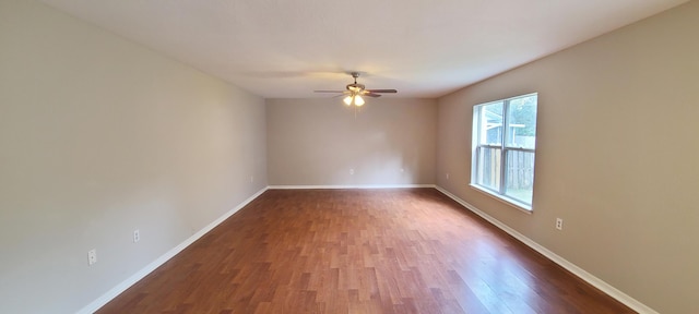 spare room featuring dark hardwood / wood-style floors and ceiling fan