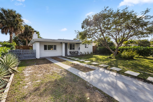 single story home featuring a front yard