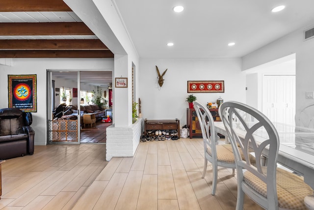 interior space featuring beamed ceiling and light wood-type flooring