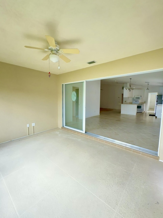 interior space with ceiling fan with notable chandelier