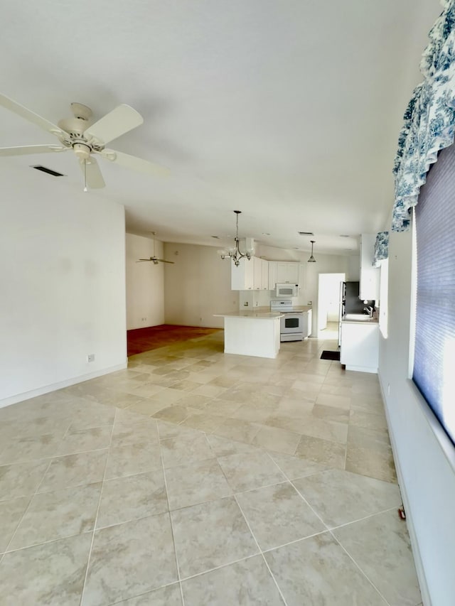 unfurnished living room with light tile patterned floors and ceiling fan with notable chandelier