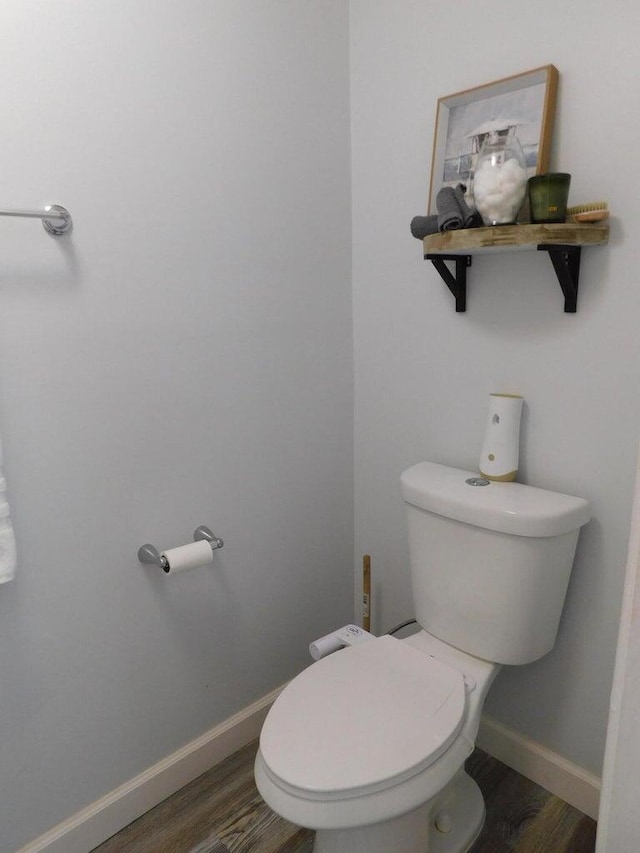 bathroom featuring wood-type flooring and toilet