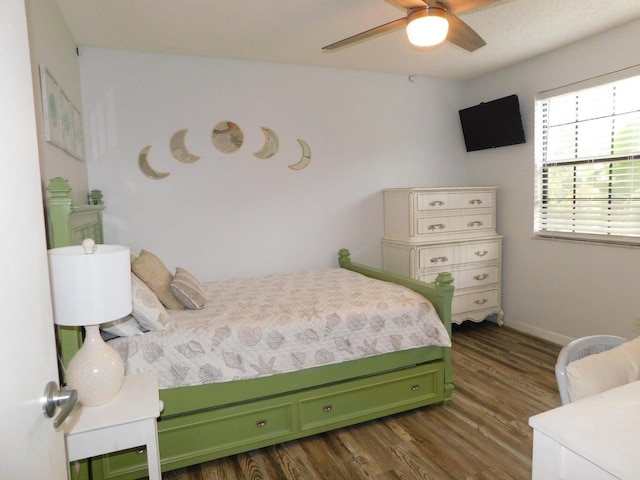 bedroom featuring dark hardwood / wood-style floors and ceiling fan