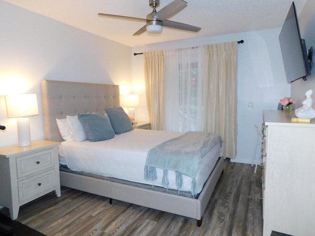 bedroom with dark wood-type flooring and ceiling fan