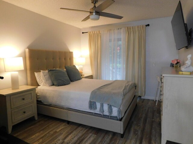 bedroom featuring dark hardwood / wood-style flooring, ceiling fan, and a textured ceiling