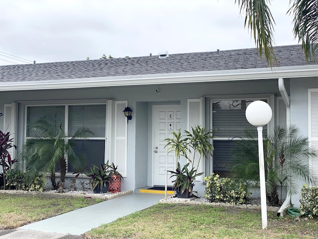 doorway to property with a yard