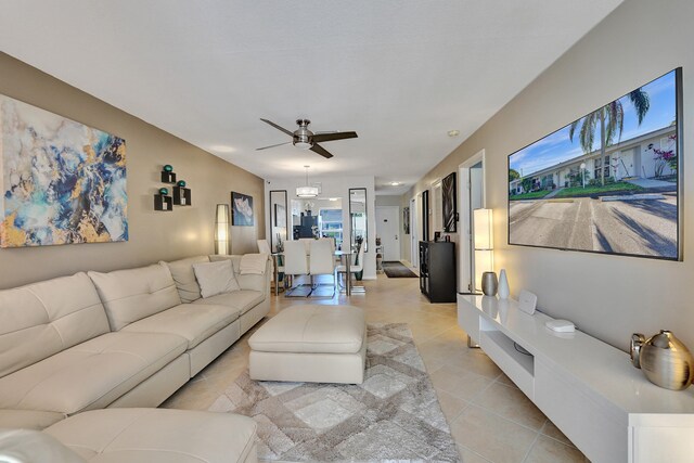 tiled living room with ceiling fan