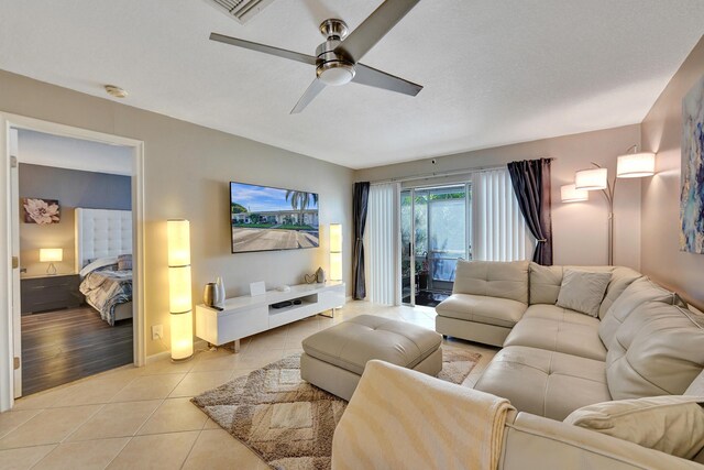 living room with ceiling fan and light tile patterned floors