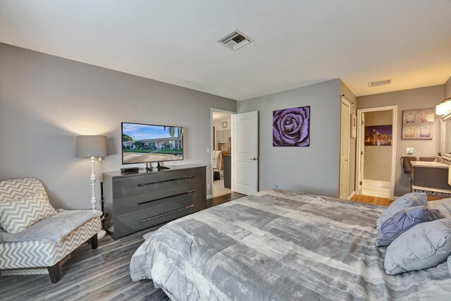 bedroom with dark wood-type flooring