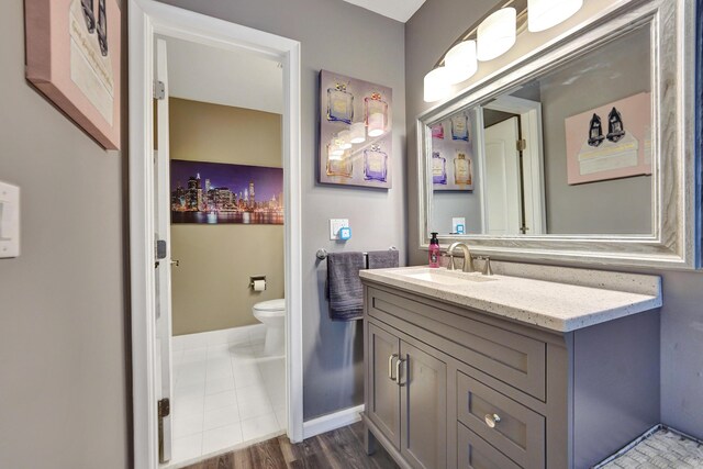 bedroom featuring hardwood / wood-style flooring and connected bathroom