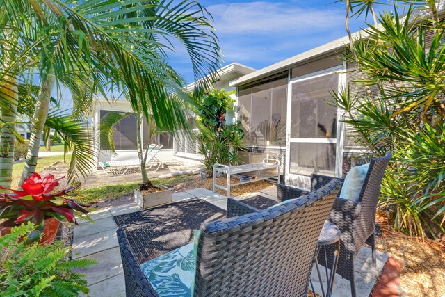 view of patio / terrace featuring a sunroom