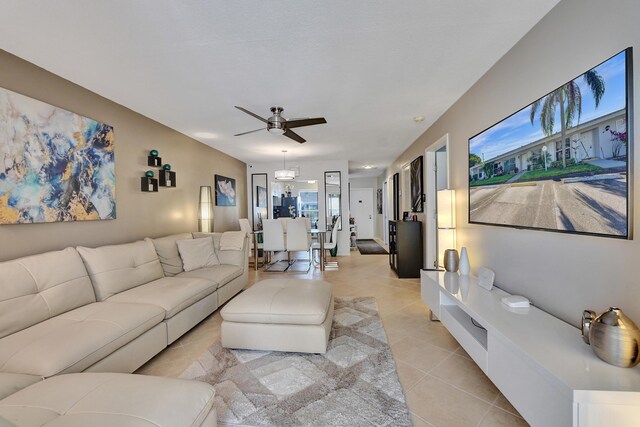 living room featuring light tile patterned floors and ceiling fan