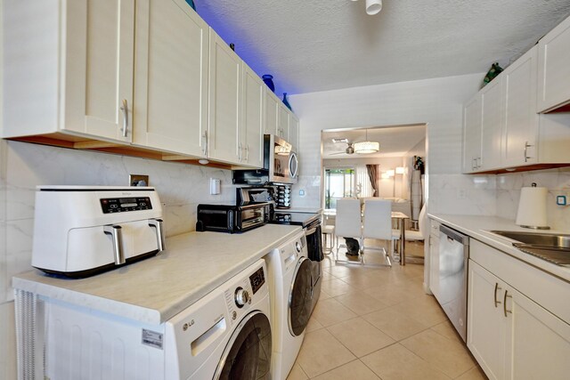 kitchen featuring white cabinetry, pendant lighting, decorative backsplash, light tile patterned flooring, and appliances with stainless steel finishes