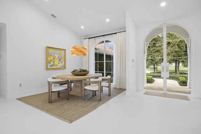 dining area with a healthy amount of sunlight and vaulted ceiling