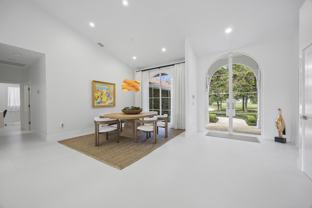 dining room with high vaulted ceiling