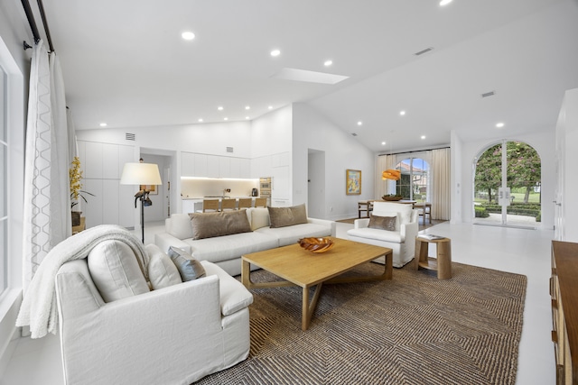 living room featuring high vaulted ceiling