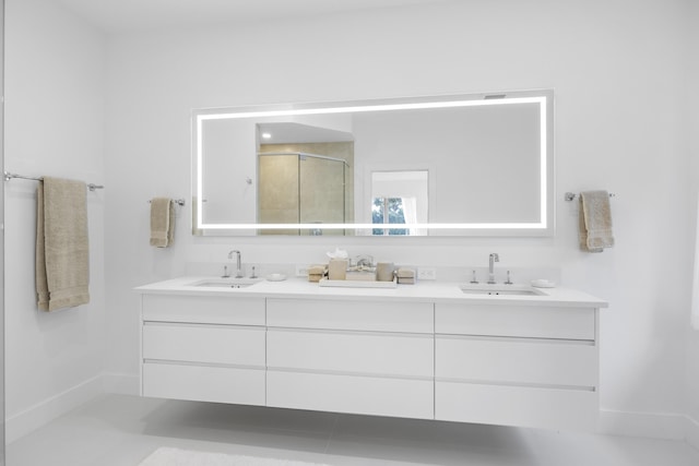 bathroom with vanity and a shower with shower door