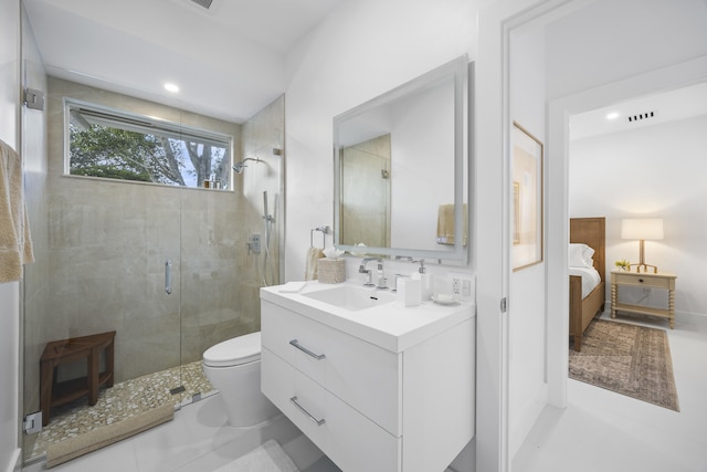 bathroom with tile patterned floors, an enclosed shower, vanity, and toilet