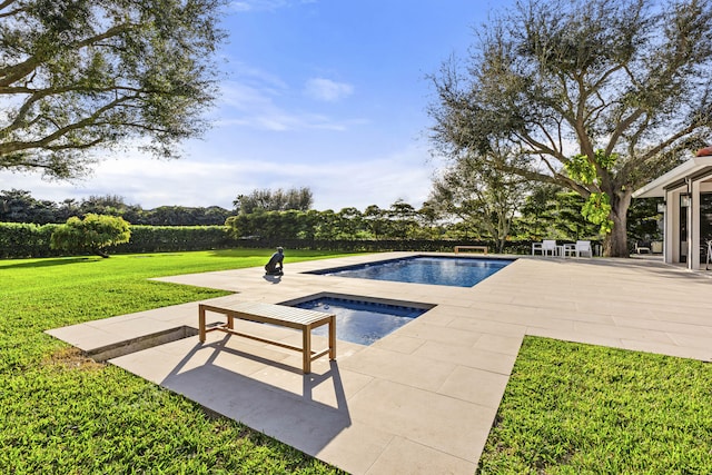 view of swimming pool with a patio, a lawn, and an in ground hot tub