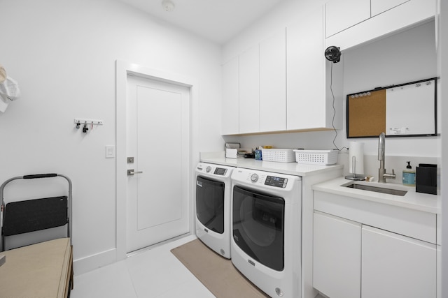 laundry area with washer and dryer, cabinets, light tile patterned floors, and sink