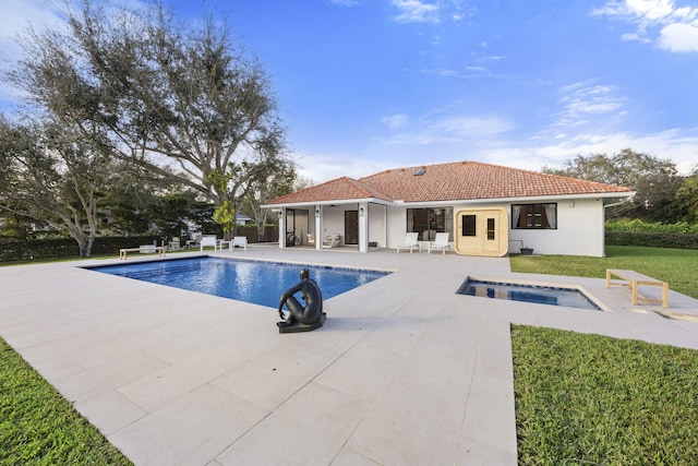 view of swimming pool featuring a patio and an in ground hot tub