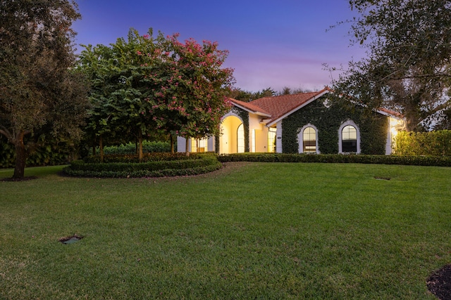 view of front of property with a lawn