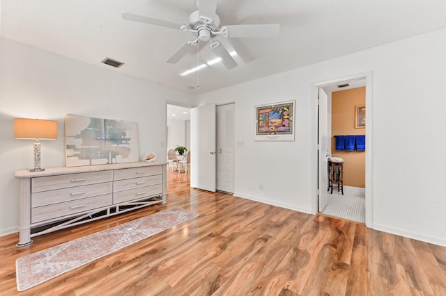 bedroom featuring ceiling fan, a closet, and wood-type flooring