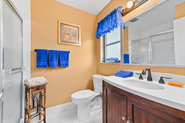 bathroom with tile patterned floors, vanity, toilet, and walk in shower