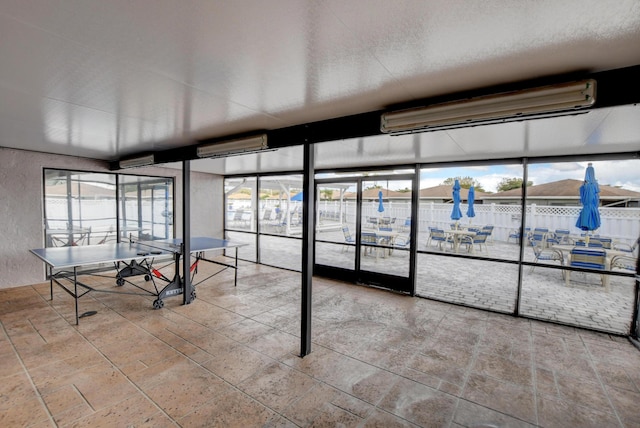 unfurnished sunroom with a wall mounted AC