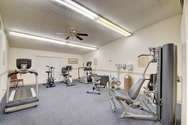 gym featuring ceiling fan and a textured ceiling