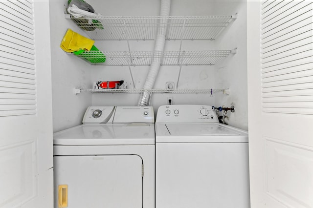 laundry area featuring washing machine and clothes dryer