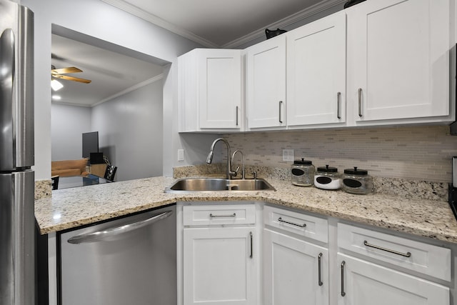 kitchen with sink, ornamental molding, appliances with stainless steel finishes, decorative backsplash, and white cabinets