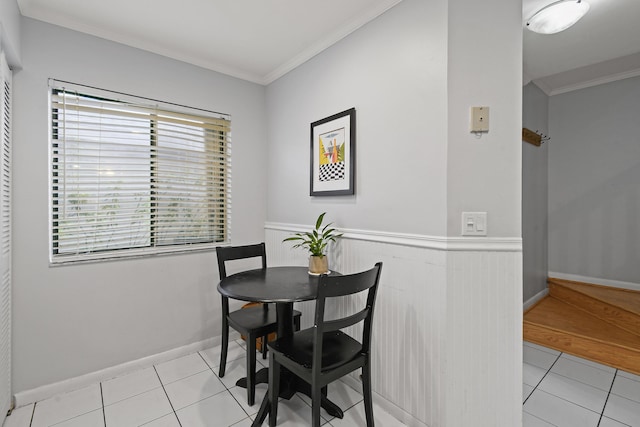 dining area featuring light tile patterned floors and ornamental molding