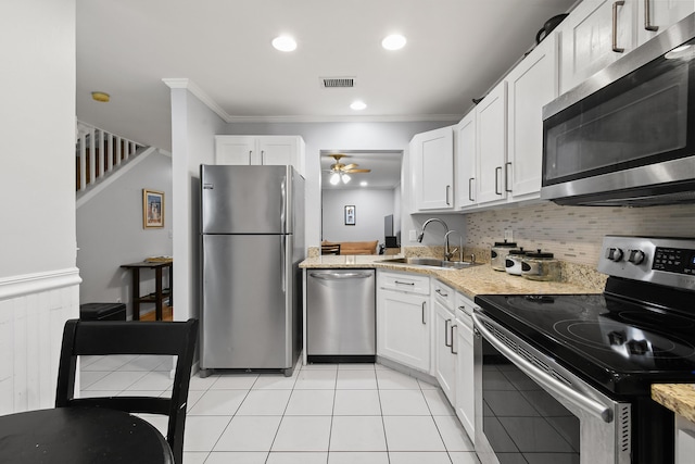 kitchen with crown molding, stainless steel appliances, sink, and white cabinets