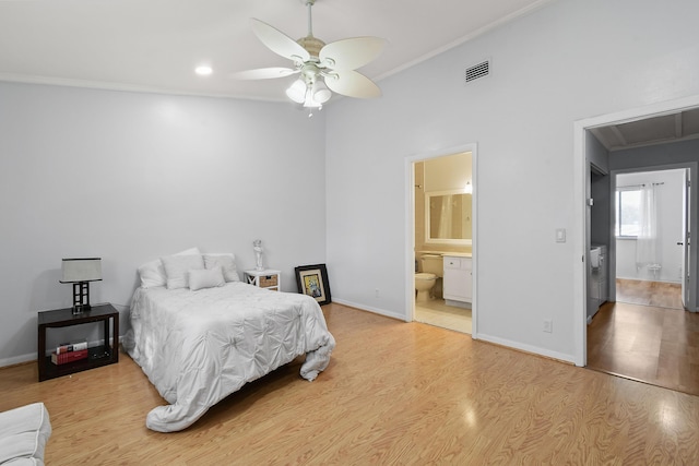 bedroom featuring hardwood / wood-style flooring, crown molding, ceiling fan, and ensuite bath