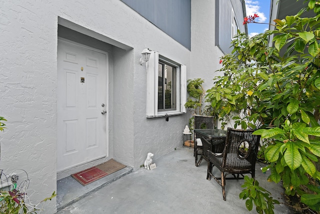 entrance to property with a patio