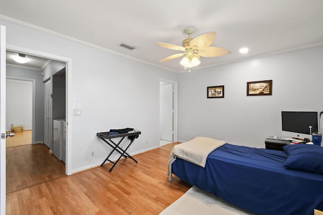 bedroom with ornamental molding, washer / dryer, ceiling fan, and light hardwood / wood-style floors