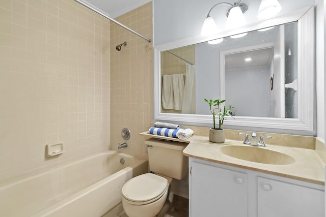 full bathroom with tiled shower / bath, vanity, and toilet