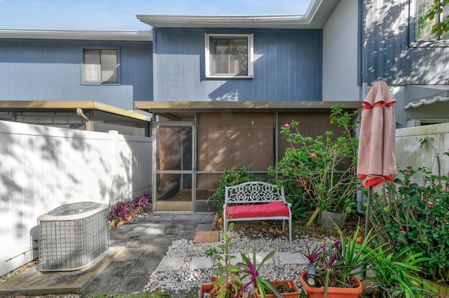 rear view of property featuring cooling unit and a patio