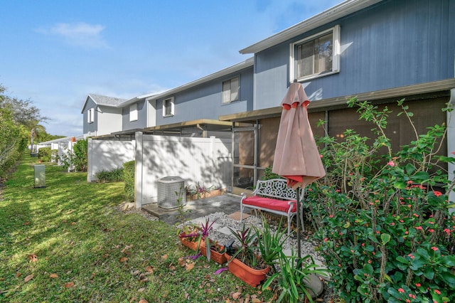 rear view of property featuring a yard and a patio