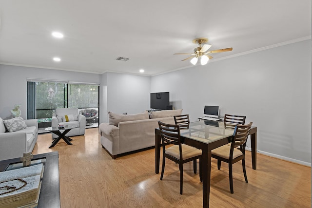 dining room featuring ornamental molding, ceiling fan, and light hardwood / wood-style floors